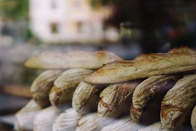 Baked breads at store seen through glass