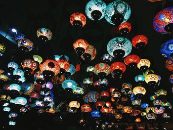 Low angle view of illuminated lanterns hanging at night