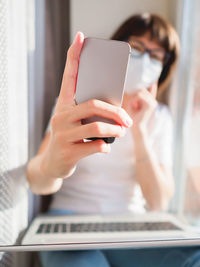 Cropped hand of woman doing selfie