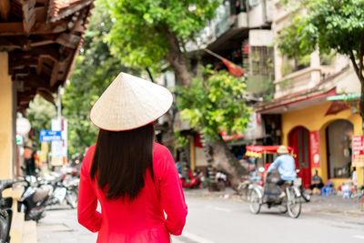 Rear view of woman standing in city