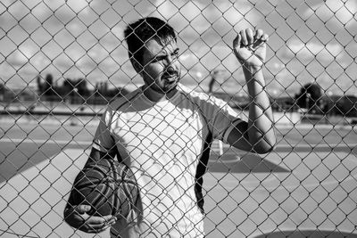 People playing seen through chainlink fence