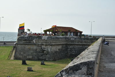View of building by sea against clear sky