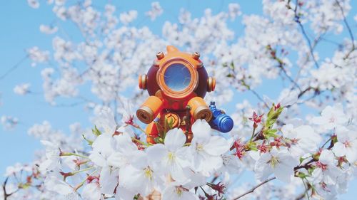 Alibaba mini figure against cherry blossom 