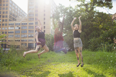 Three young women jumping