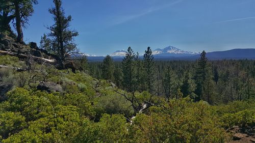 Scenic view of mountains against blue sky