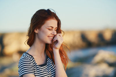 Smiling woman standing outdoors