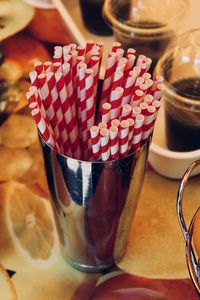 High angle view of straws in metal cup on table