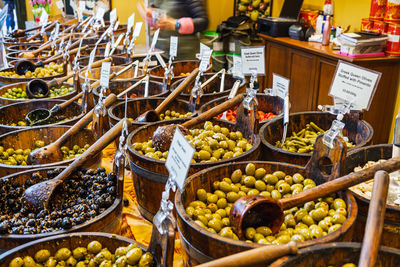 Olives displayed in bowls at vibrant borough market food stall. london, uk, 29 march 2024