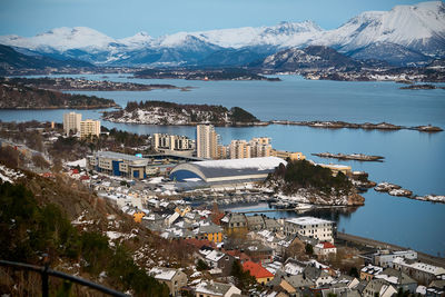 High angle view of townscape by sea against sky