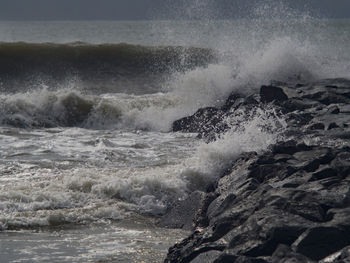 Waves breaking against sea