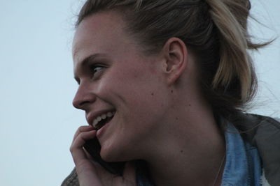 Close-up of young woman against gray background