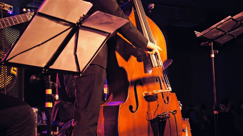 Midsection of man playing cello during event
