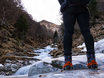 Low section of man walking on mountain