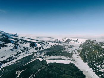 Scenic view of snow covered mountains against sky