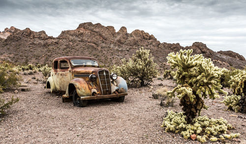 Abandoned truck on mountain against sky