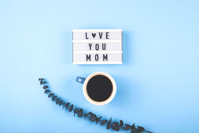 Information sign on table against blue background