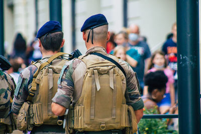 Rear view of people standing in city