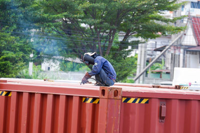 Low angle view of man standing against building