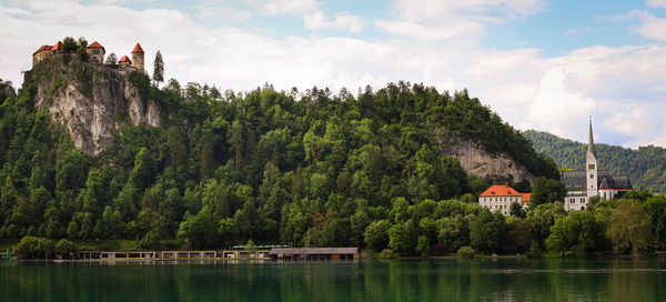 Panoramic view of lake and buildings against sky