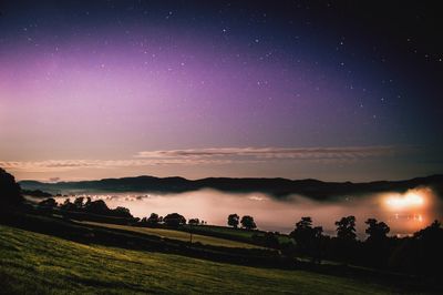 Scenic view of field against sky at night
