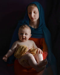 Portrait of young woman with baby