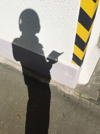 Shadow of woman on road