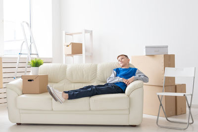 Young man sitting on sofa at home