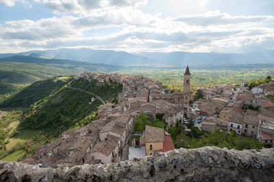 Castle on mountain against cloudy sky