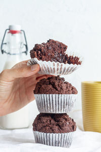 Close-up of hand holding chocolate cake