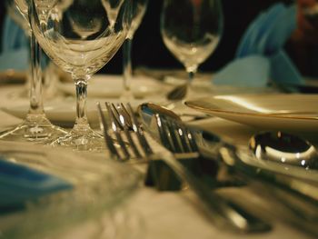 Close-up of drinking glasses with forks on table