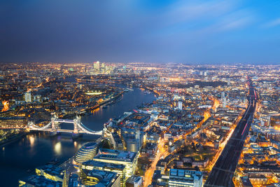 High angle view of illuminated city buildings at night