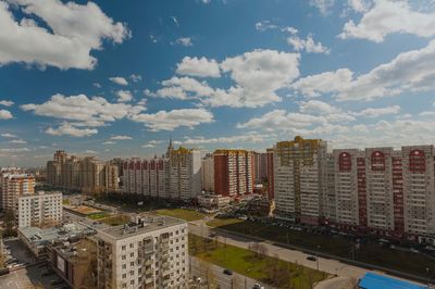 View of cityscape against cloudy sky