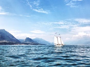 Sailboat sailing on sea against sky