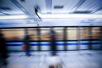 Blurred motion of train at railroad station