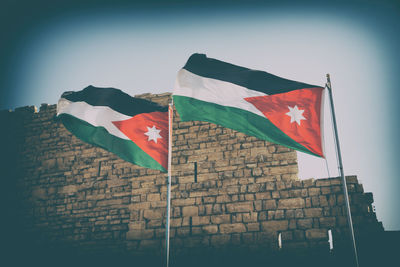 Low angle view of flag against sky