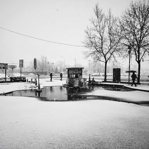 Snow covered city against clear sky