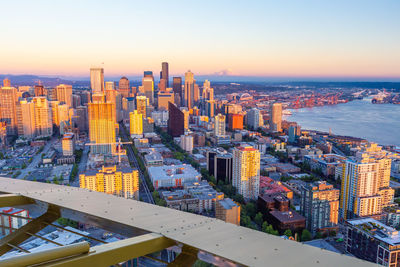 High angle view of city buildings against sky during sunset