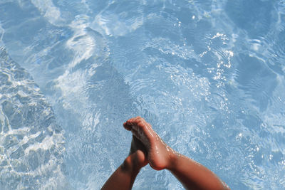 Low section of child in swimming pool