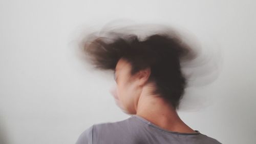 Close-up of man against white wall