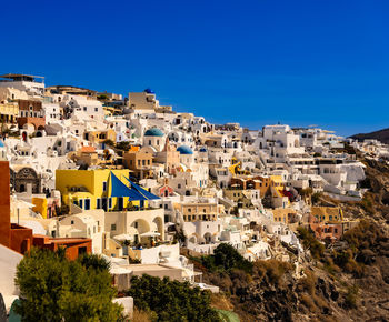 High angle view of townscape against clear blue sky