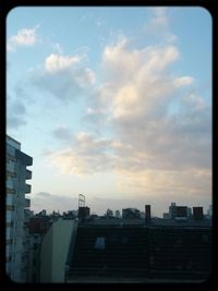 View of buildings against cloudy sky