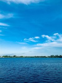 Scenic view of lake against blue sky