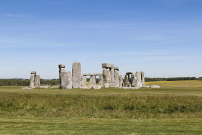 Old ruins on field against sky