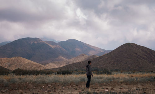 Full length of man standing on land against sky