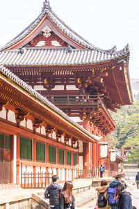 People in temple outside building