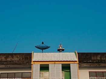 Low angle view of building against clear blue sky