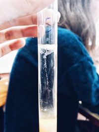 Close-up of hand holding glass of water