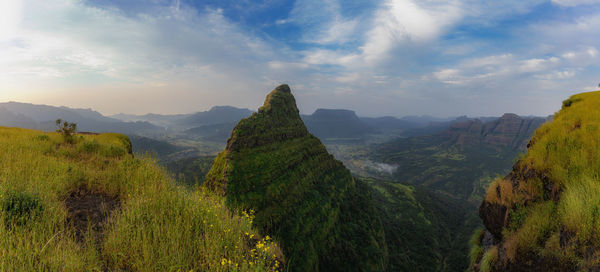 Panoramic view of trees and mountains against sky