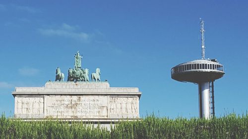 Low angle view of statue against blue sky