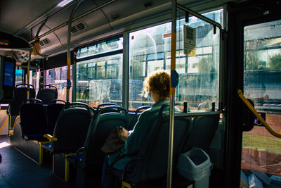 Rear view of man traveling in train